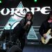 Europe live auf der Bühne bei einem Rockkonzert mit Sänger, Gitarrist und beleuchtetem Bandlogo