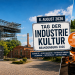 KI-generierte Illustration zum Tag der Industriekultur Brandenburg 2026 mit Schiffshebewerk, historischen Fabriken und Glasmacherhandwerk